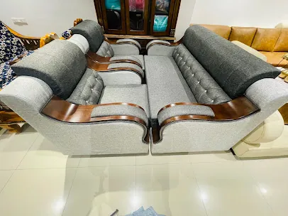 Grey fabric sofa set with wood-trim arms and button-tufted backrests, two matching sofas facing each other in the showroom